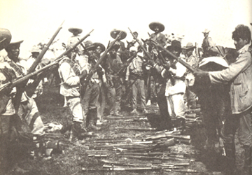 CARRANZA'S MEN PILING UP THE GUNS THEY HAD CAPTURED FROM PANCHO VILLA'S MEN