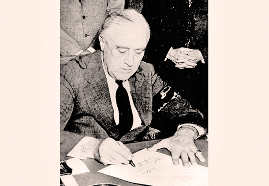 Photo of President Franklin D. Roosevelt signing the Declaration of War against Japan - December 8, 1941
