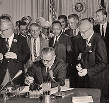 President Lyndon B. Johnson signs the Voting Rights Act of 1965